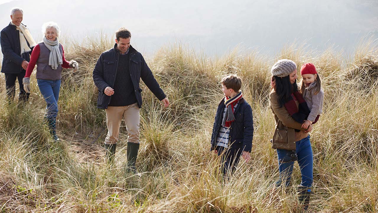 A family hiking on the side of the mountain
