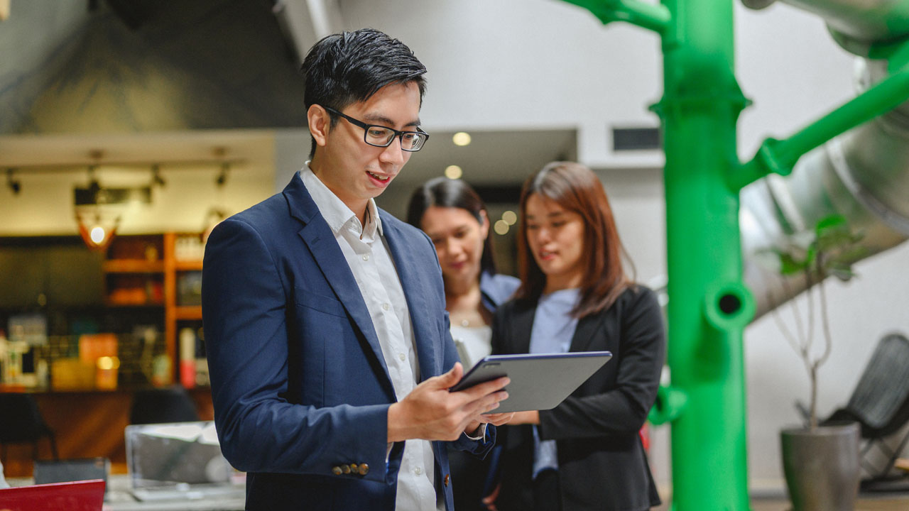 A man wearing glasses checking his list